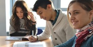 3 people setting at a table to learn a new language