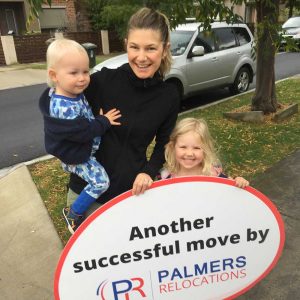 Happy Customer Holding a Palmers Sign