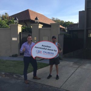 Happy Customer Holding a Palmers Sign