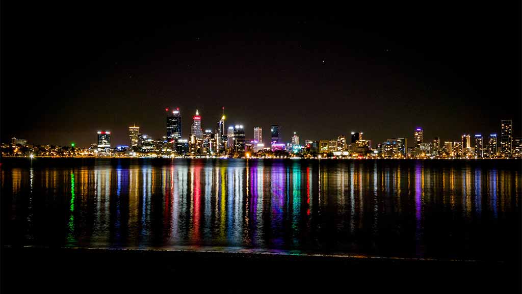 perth cbd lights reflecting on the swan river at night time