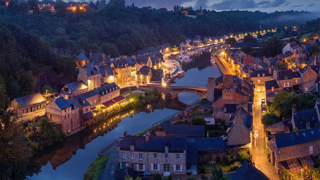 small village in france with lights and a river