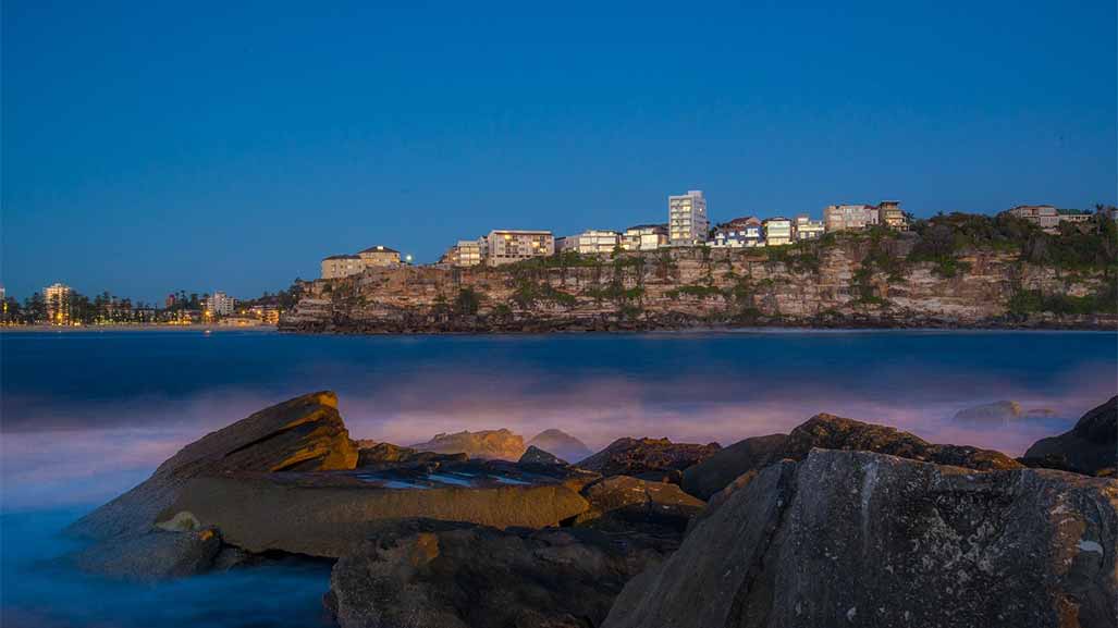 view of manly vale beach with houses in background